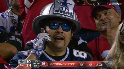 Sad Cowboys Fan on His Phone During Blowout Loss to 49ers Became a Sad Meme
