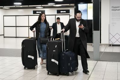 Emotional travellers arriving in UK describe Hamas rocket attacks