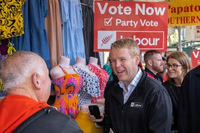 New Zealand political candidates dance and hug on the final day of election campaign