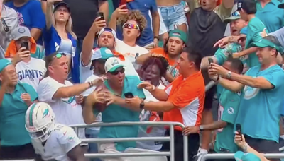 Tyreek Hill gave a Dolphins fan signed gear after a touchdown ball mix-up involving his mom