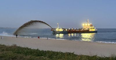 Dredge starts spraying sand into the breakers at eroded Stockton beach