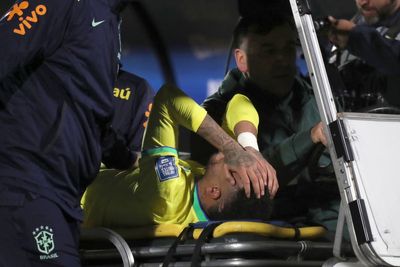 Neymar taken off on a stretcher playing for Brazil against Uruguay