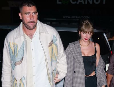 Travis Kelce addresses photos of him holding Taylor Swift’s hand like a football