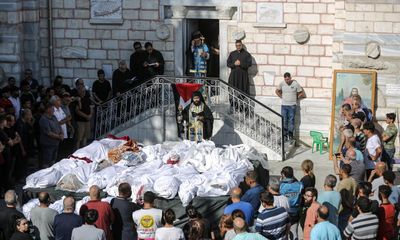 ‘Destruction chased them’: funeral held for those killed in Gaza church airstrike