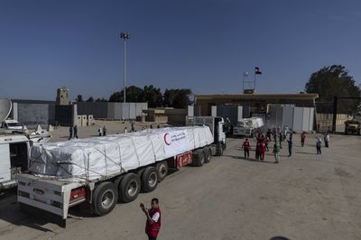 20 trucks of aid come into Gaza, but no passage for foreign nationals seeking to leave