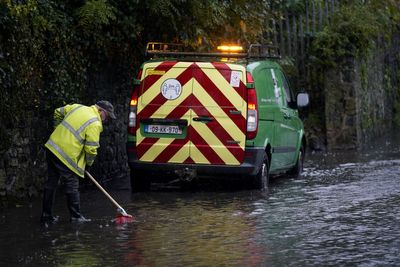Children carried out of flooded school amid heavy rainfaill in Ireland