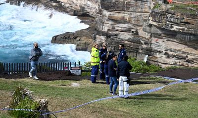 Body recovered from water as police search for man wanted over death of Sydney school coach