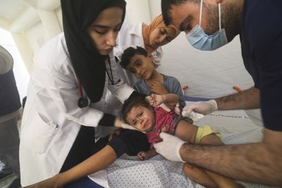 ‘So world knows’: Gaza parents mark children’s names on bodies amid bombing