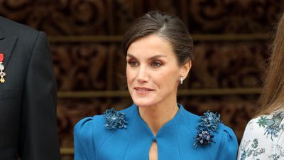 Queen Letizia oozes 1920s glamour as she pairs a fur-collared cape with a figure-hugging cobalt blue midi dress