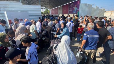 Desperate scenes at Rafah crossing as first British nationals flee Gaza, but many still unsure if they can leave