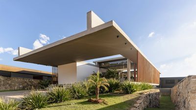 This Brazilian house uses concrete and wood to screen a sleek horizontal living space