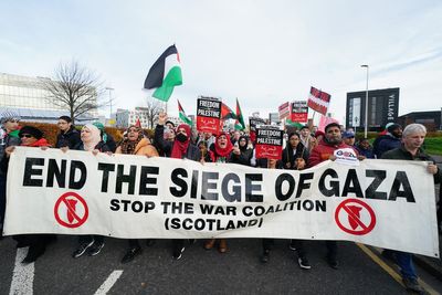 Protesters hold up mock body bags in protest at Gaza war