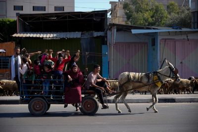 Growing numbers of Palestinians flee on foot as Israel says its troops are battling inside Gaza City