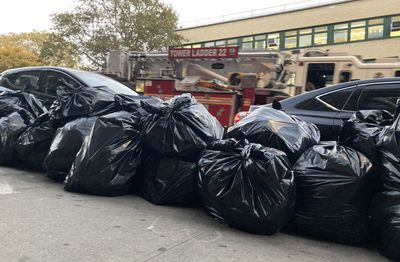 Curbside trash is a problem in NYC. Officials have a not-so-novel fix: plastic bins