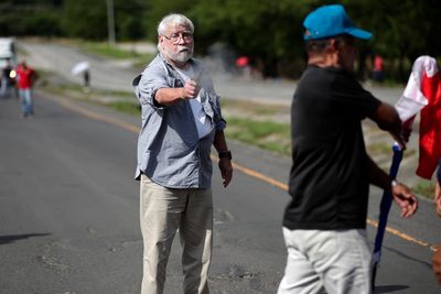Elderly lawyer shoots dead two climate protesters blocking highway