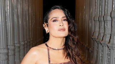 Salma Hayek looks totally cool in this metallic rose gold skin-tight gown