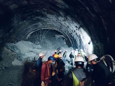 Rescuers dig to reach 40 workers trapped in collapsed road tunnel in north India