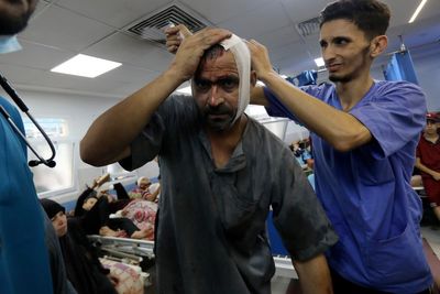 Medics ‘dig mass grave’ at Gaza’s largest hospital – where hundreds are trapped inside by intense fighting