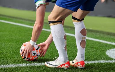 Why do so many footballers cut holes in their socks?