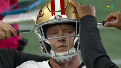 Christian McCaffrey getting his 49ers helmet tightened from both sides inspired so many robot jokes