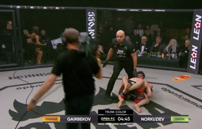 Video: Just when you think you’ve seen it all, a cameraman got trapped in the cage after a fight started