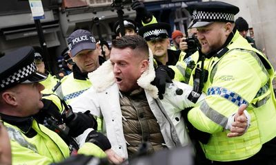 Tommy Robinson charged over refusal to leave march against antisemitism
