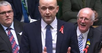 Why are SNP MPs wearing red ribbons at PMQs?