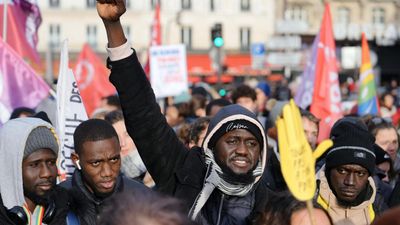 Protest in Paris against immigration law as parliamentary debate continues