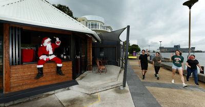 Cafe owner offers free Santa photos to help locals feeling the pinch