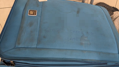 Airport worker writes profane message on baby’s suitcase telling parents to ‘stop checking in late’