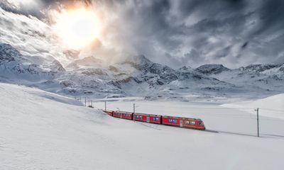 ‘The reflection of snow-tipped trees in an ice-cold lake melted hearts’: readers’ favourite winter train rides