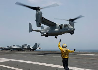 Divers recover the seventh of 8 crew members killed in crash of a US military Osprey off Japan