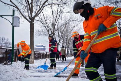 Snow blankets northern China, closing roads and schools and suspending train service