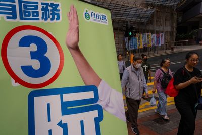 Hong Kong leader praises election turnout as voter numbers hit record low