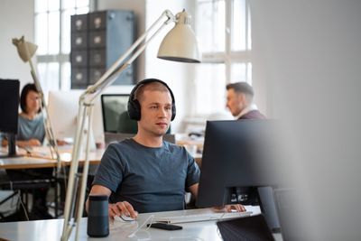 Workers are turning to music as stressful workplaces become the norm. Here’s the science of how it works–and how to find your soundtrack to success