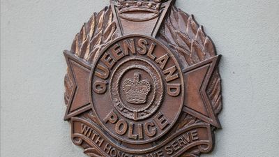 Officer attacked after men found asleep in car with gun