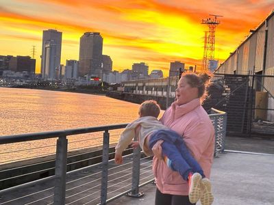 Amy Schumer Carrying Baby Unconventionally Against Picturesque Backdrop