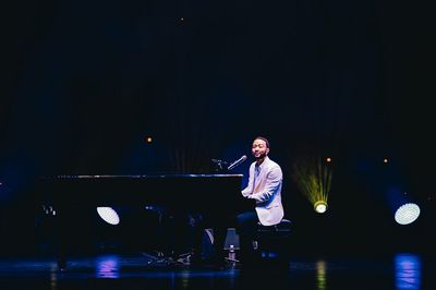 Mesmerizing Red Backdrop: John Legend and Niall Horan's Musical Magic