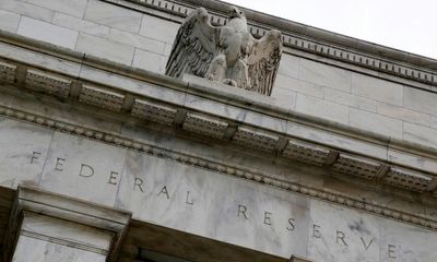 Dow closes at record high after Fed signals it will cut interest rates in 2024