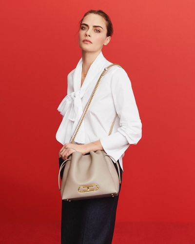 Cara Delevingne Captivates in White, Chic Shoulder Bag Completes Look