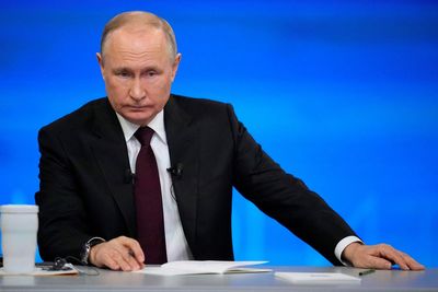 Putin confronted by critical text messages beamed on screen at year-end news conference