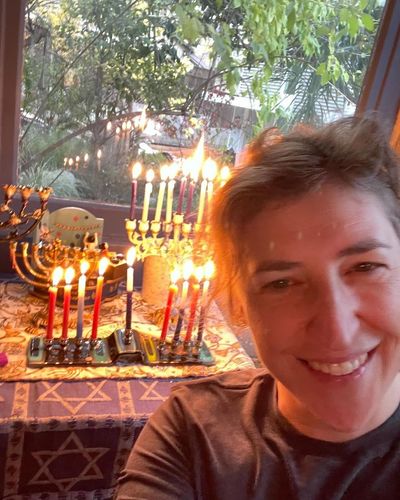Candlelit Moment Captured by Mayim Bialik's Selfie Smile