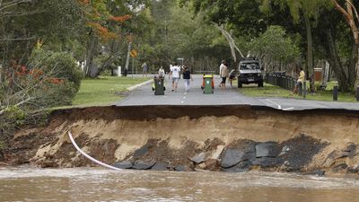 Heroic flood rescues as town evacuation postponed