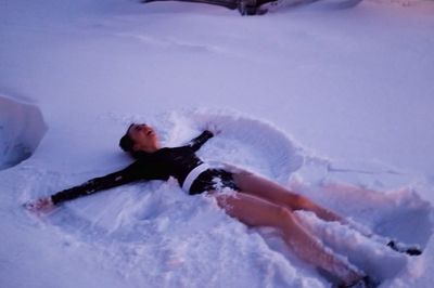 Joyful Elegance: Lily Collins in Black Amidst Snowy Landscape Fun