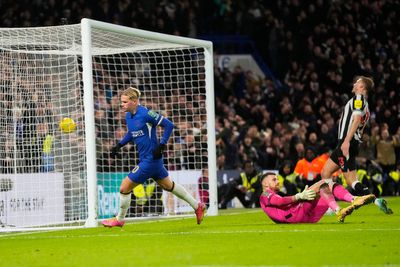 Newcastle goalkeeper Martin Dubravka confronted by a fan on the field at Chelsea