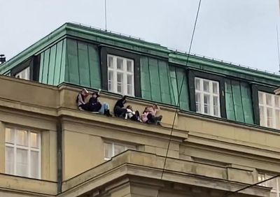 Terrified students hang from balcony to hide from gunman during Prague shooting