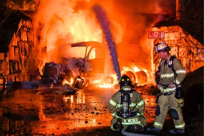 Truck carrying gas hits railroad bridge and explodes as a train passes overhead