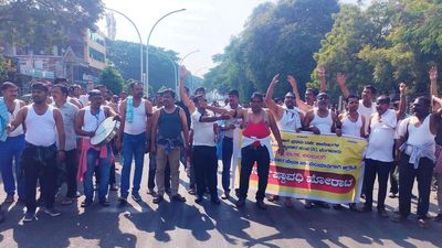 Guest lecturers take out shirtless protest march on completion of one month of indefinite protest