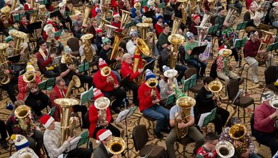 ‘It’s a warm hug’: Hundreds of tubas fill the Palmer House with velvety holiday tunes