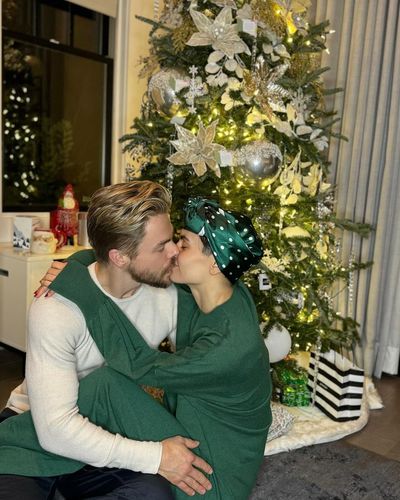 Derek Hough and Partner Radiate Holiday Spirit in Festive Photo